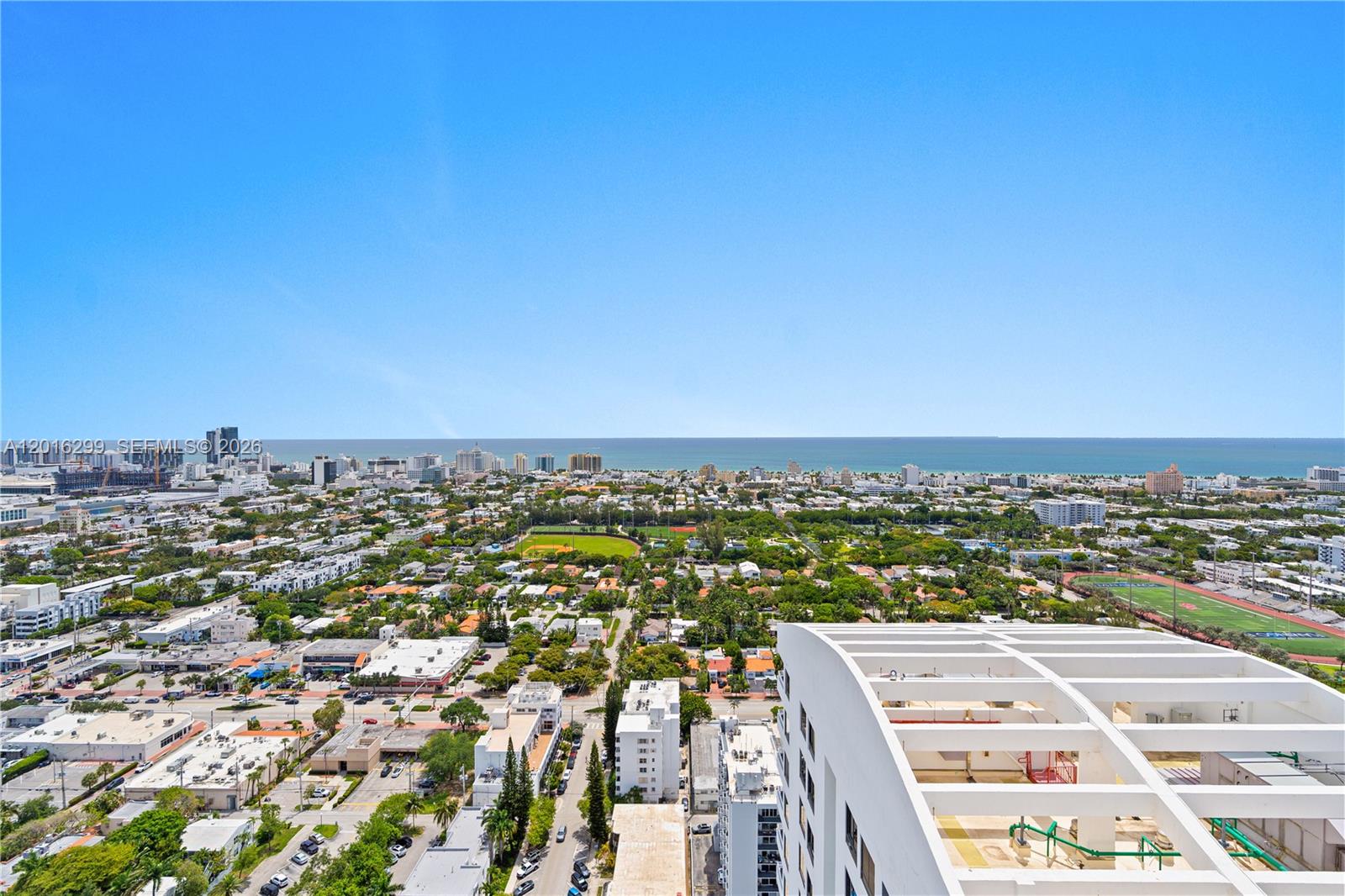An elevated view shows a city landscape with a park, buildings, and the ocean beyond — 1330 West Ave, Miami Beach FL 33139, MIAMI BEACH, FL