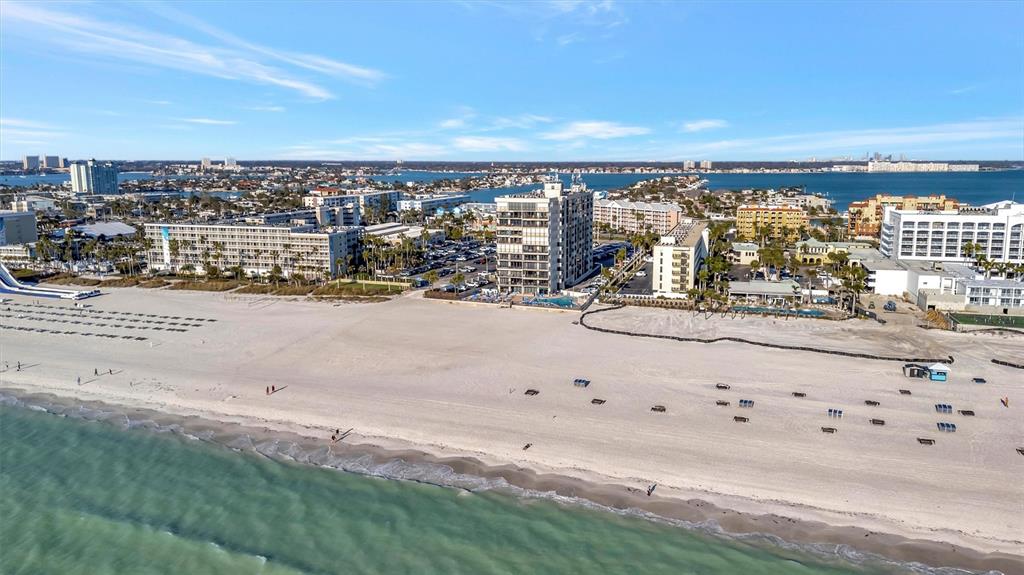 An aerial view shows a sandy beach with several beachfront hotels and resorts — 5396 GULF BOULEVARD UNIT 407, ST PETE BEACH, FL