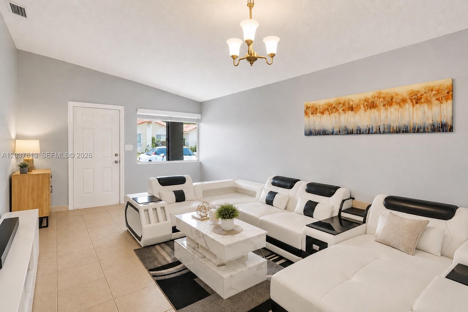 A living room features a white and black sectional sofa, marble coffee table, and tile flooring — 2886 W 74th Pl, Hialeah FL 33018, HIALEAH, FL