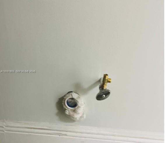 A wall-mounted water supply valve and a drain pipe opening are visible on a wall — 6101 W Atlantic Blvd # 205A, Margate FL 33063, MARGATE, FL