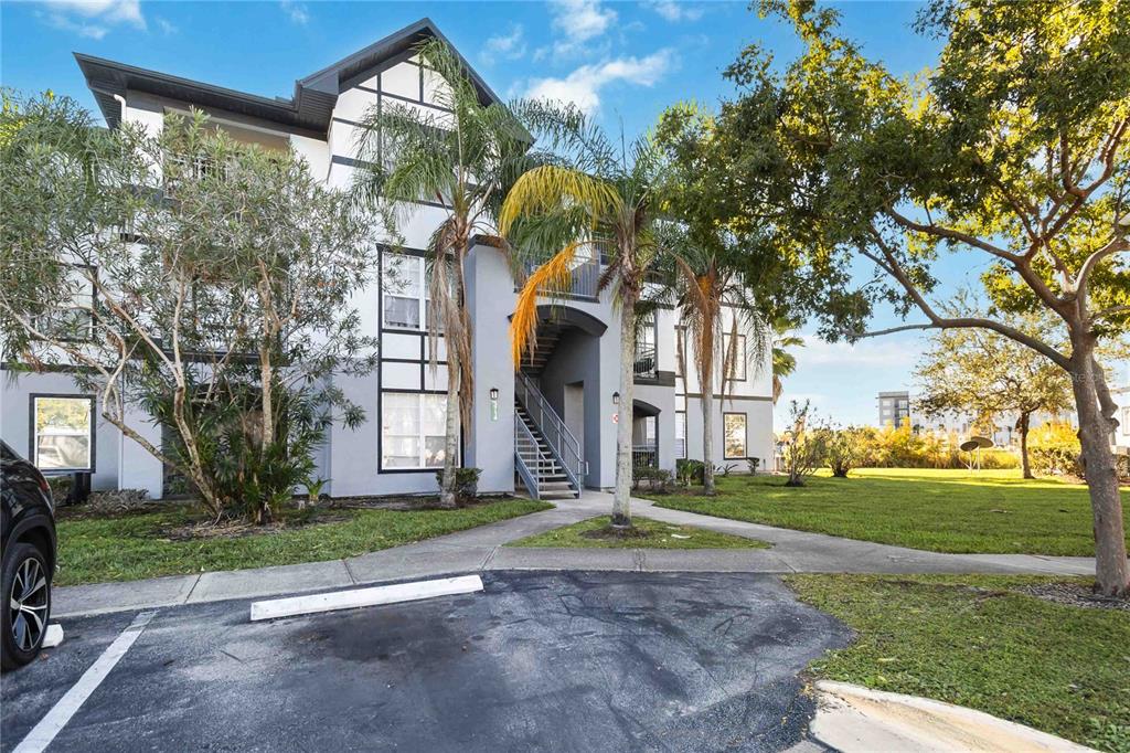 Exterior view of a multi-story apartment building with stairs leading to upper units — 3714 PALM DESERT LANE UNIT 5336, ORLANDO, FL
