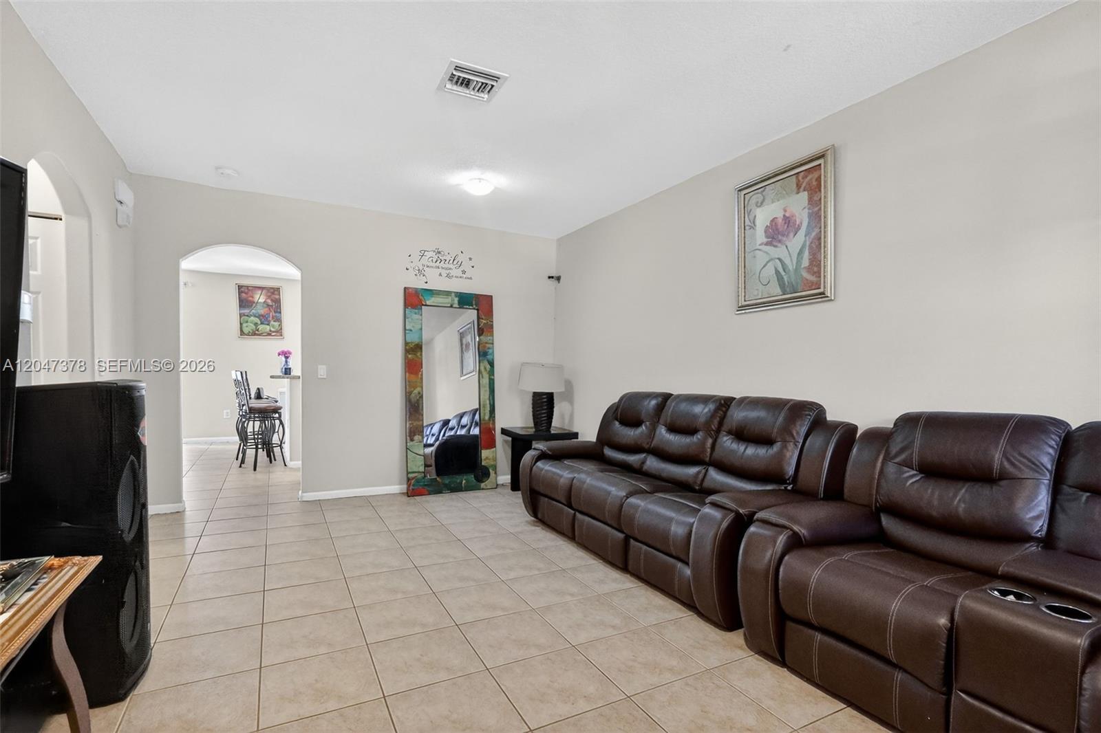 A living room features beige tile floors, a brown leather sofa, and a floor mirror — 2671 SW 85th Ter # 103, Miramar FL 33025, MIRAMAR, FL