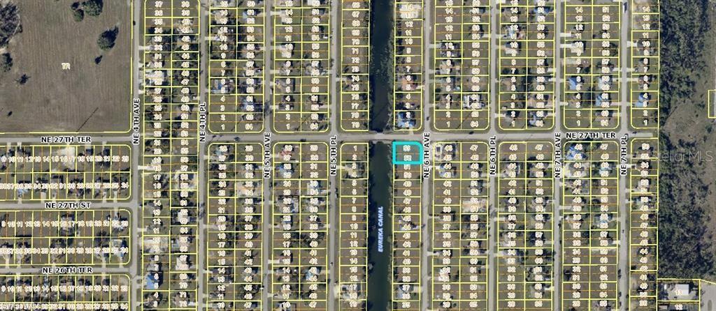 This is an aerial map showing residential lots and streets, with one specific parcel highlighted — 2710 NE 6TH AVENUE, CAPE CORAL, FL