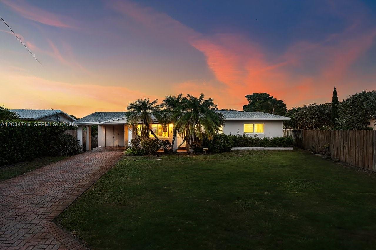 A single-story house with a brick driveway and palm trees under a sunset sky — 509 NE 29th St, Wilton Manors FL 33334, WILTON MANORS, FL