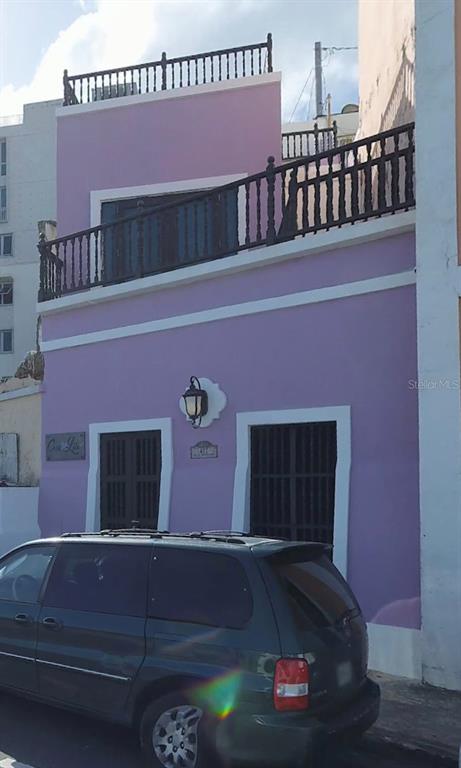 A two-story lavender building features dark wooden railings on its balconies and two ground-level entrances — 422 NORZAGARAY, SAN JUAN, PR