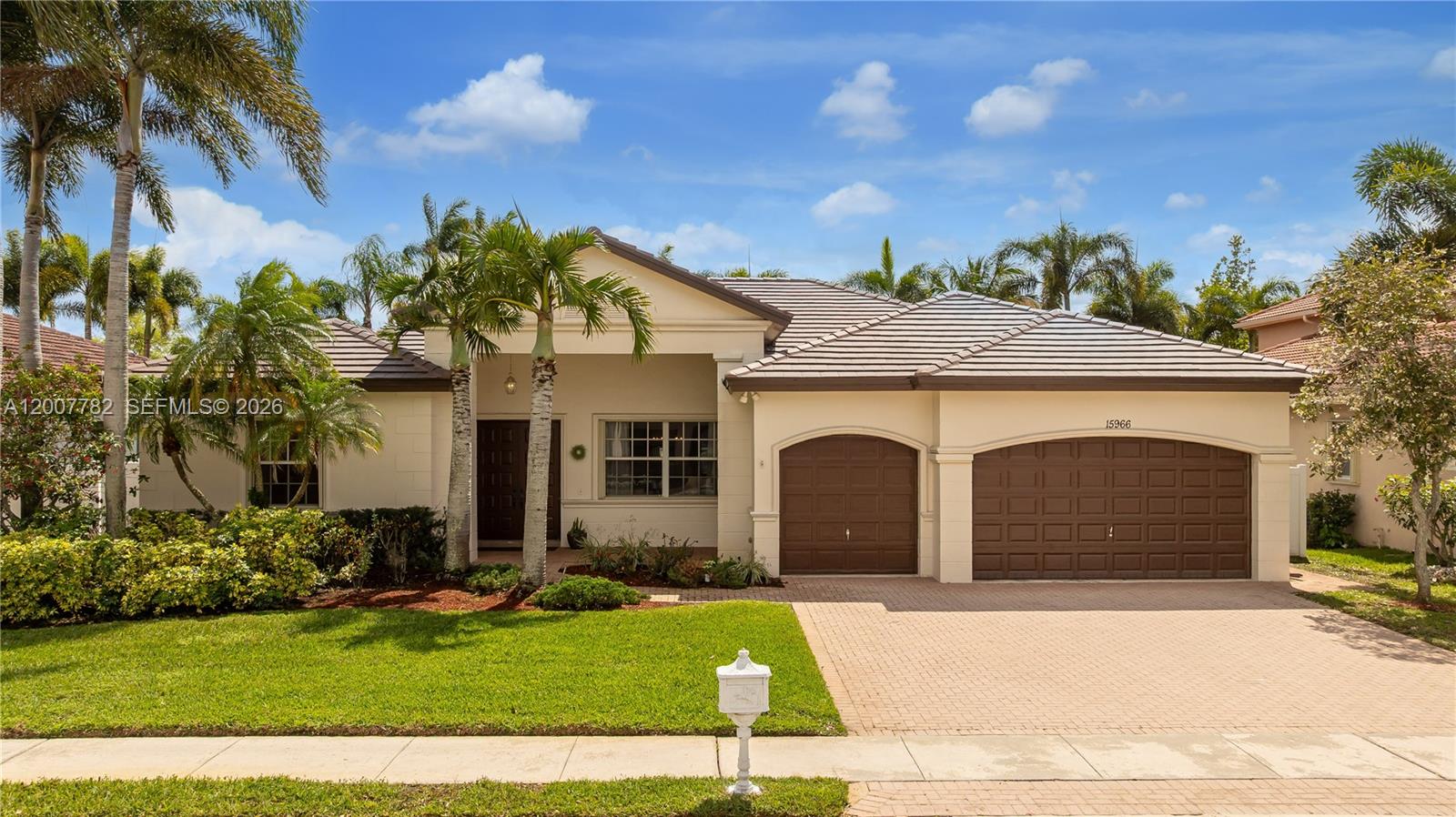A single-story house with a tiled roof, a two-car garage, and palm trees in front — 15966 SW 3rd St, Pembroke Pines FL 33027, PEMBROKE PINES, FL