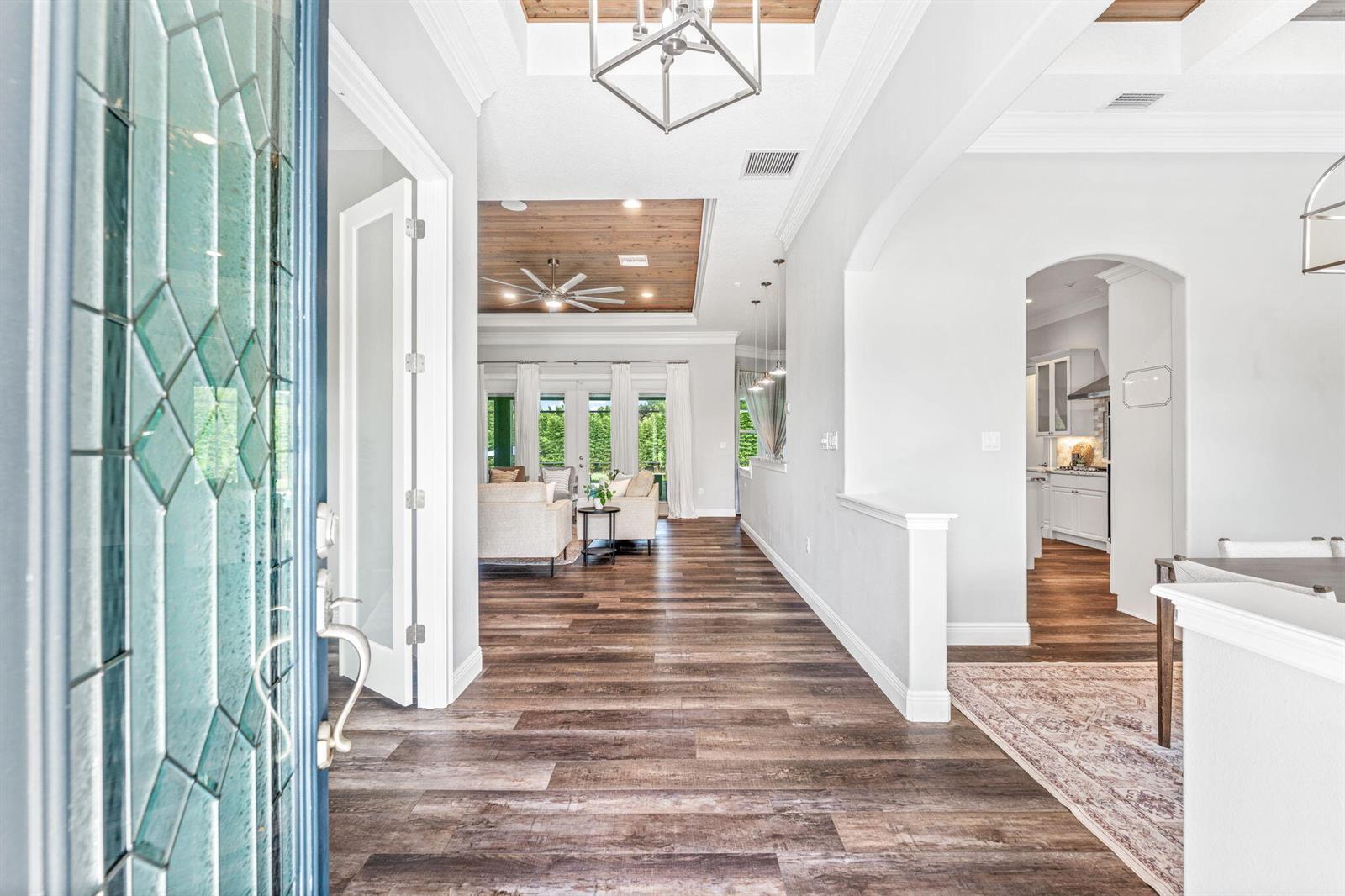 A view from an entryway looking into a living room with wood-look floors and ceilings — 2520 Tammy Drive, Mims FL 32754, MIMS, FL