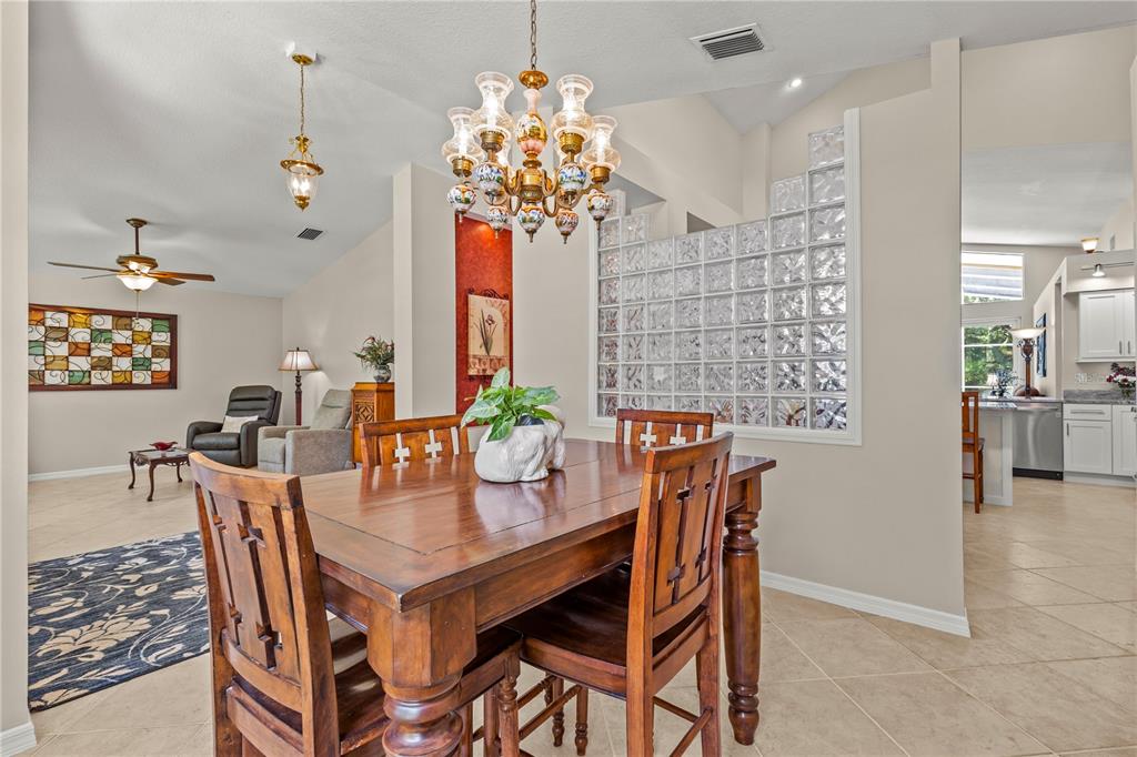 A green double front door with a transom window sits under a covered entryway — 10522 CHAMBERS DRIVE, TAMPA, FL