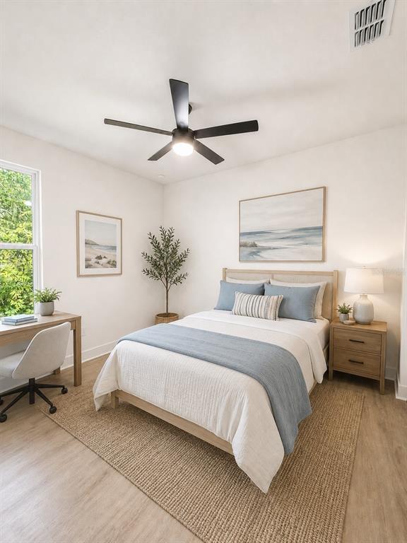 A bedroom features a bed, desk, ceiling fan, and light wood flooring — 25 HERNANDEZ AVENUE, PALM COAST, FL