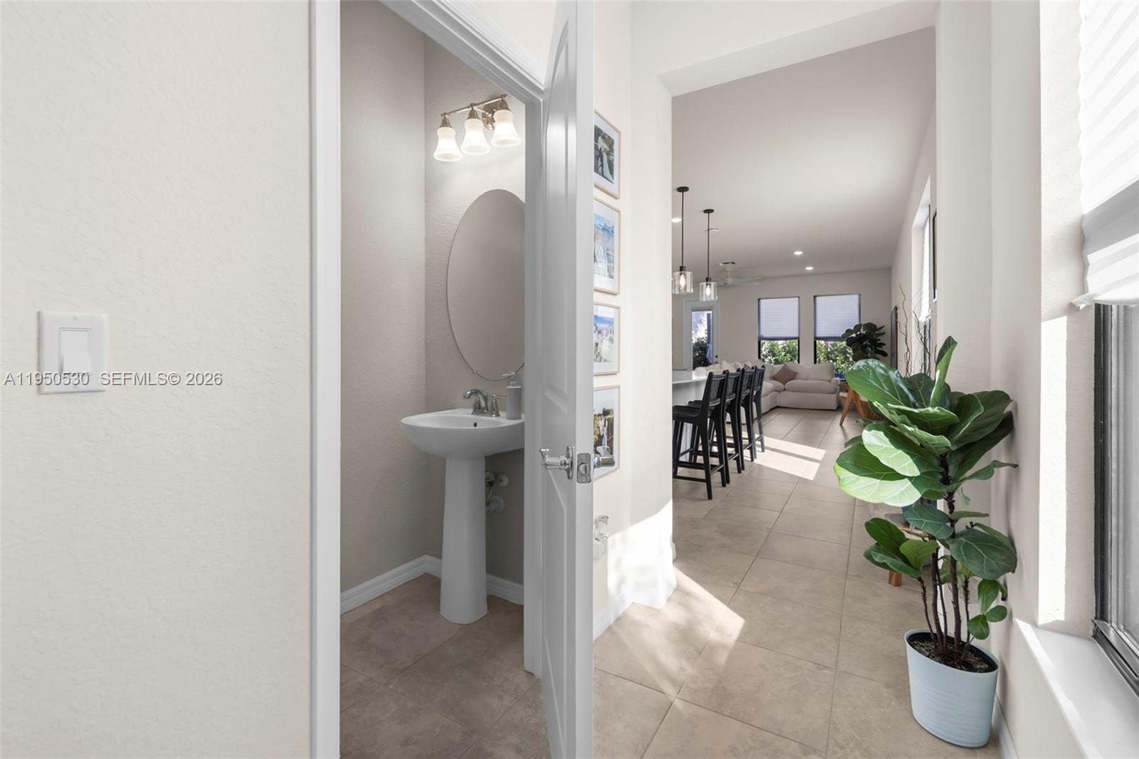 A small powder room with a pedestal sink is visible through an open doorway — 2121 S Appleton Cir S, Oakland Park FL 33309, OAKLAND PARK, FL