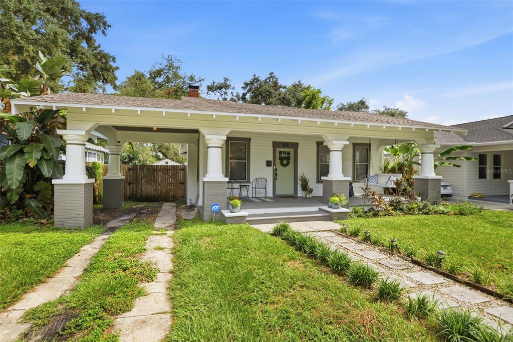 A single-story bungalow with a front porch, a carport, and a stone walkway — 906 E PATTERSON STREET, TAMPA, FL