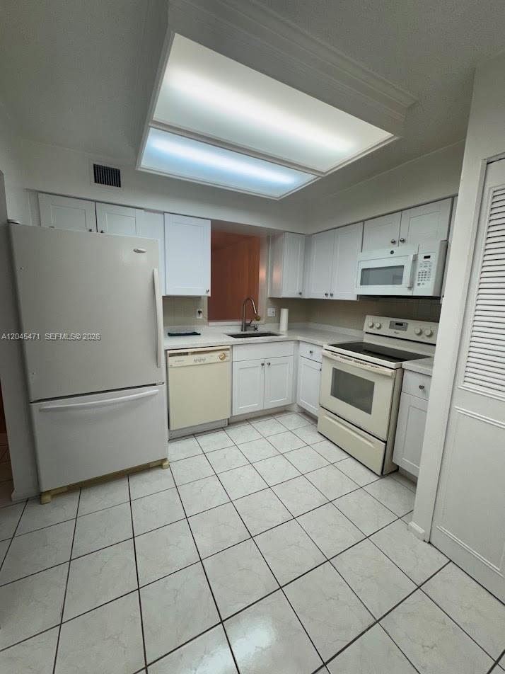 A sunroom features light-colored tile flooring, a ceiling fan, and a wall of windows — 7591 NW 1st St # 403, Margate FL 33063, MARGATE, FL