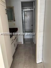 A bathroom features a vanity with a dark countertop and a separate shower area — 3774 Inverrary Blvd # 305P, Lauderhill FL 33319, LAUDERHILL, FL