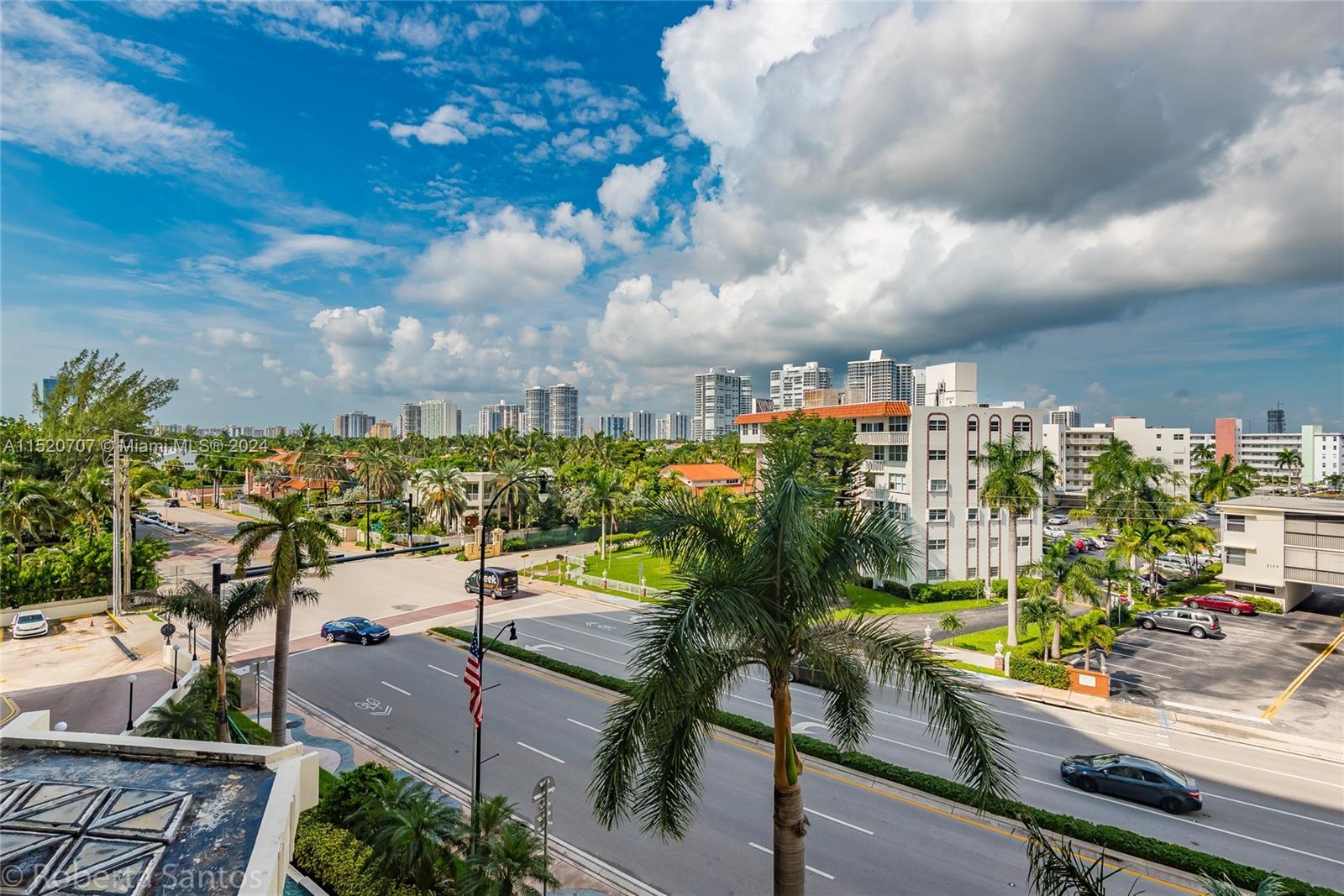 An elevated view shows a street intersection, palm trees, and residential buildings under a cloudy sky — 3180 S Ocean Dr # 422, Hallandale Beach FL 33009, HALLANDALE BEACH, FL