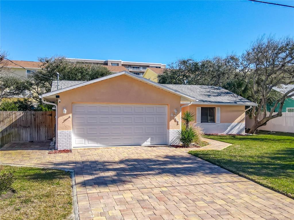 An aerial view shows a single-story house with a paved driveway and two palm trees — 4761 RIVERGLEN BOULEVARD, PONCE INLET, FL