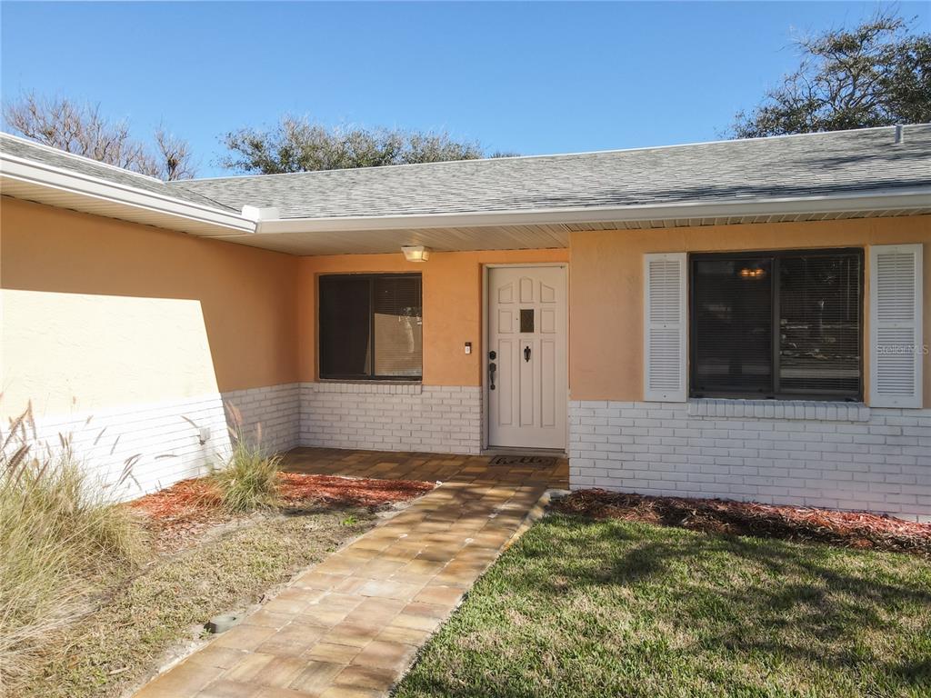 A garage with a speckled epoxy floor, a golf cart, a bicycle, and storage items — 4761 RIVERGLEN BOULEVARD, PONCE INLET, FL
