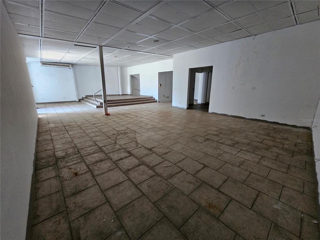 An empty commercial space features a tiled floor, a drop ceiling, and a raised platform — 151 FD ROOSEVELT AVE. AVENUE, SAN JUAN, PR