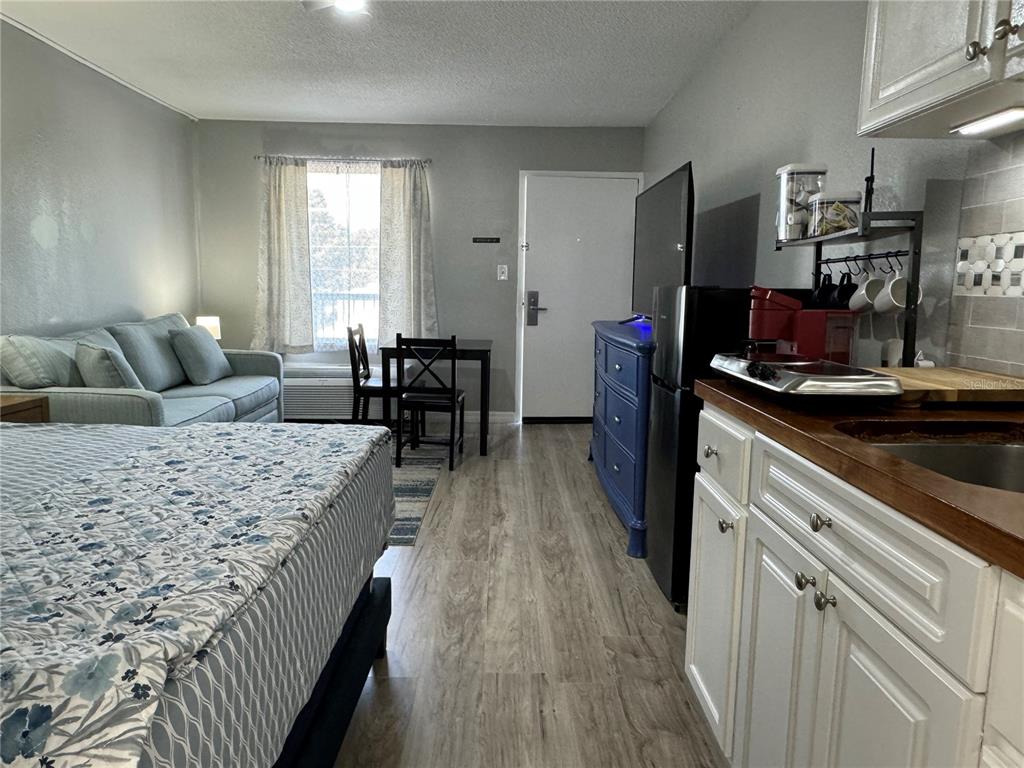 A studio apartment features a bed, a small dining table, a sofa, and a kitchenette — 7150 N TAMIAMI TRAIL UNIT S-623, SARASOTA, FL