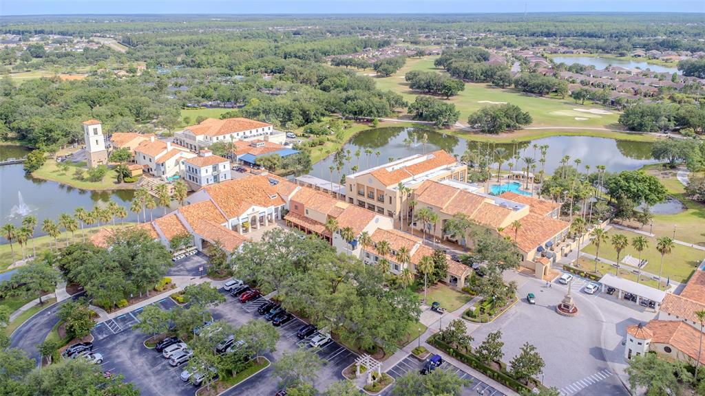 An aerial view shows a large Mediterranean-style complex with terracotta roofs, parking lots, and ponds — 537 MONTAGE LANE, KISSIMMEE, FL