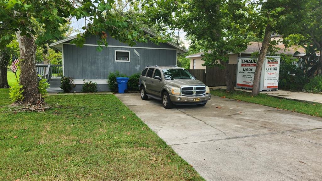 A gray house with a concrete driveway, a parked SUV, and a U-Haul storage container — 1114,1116,1118,1120&1128 WYATT  STREET, LARGO, FL