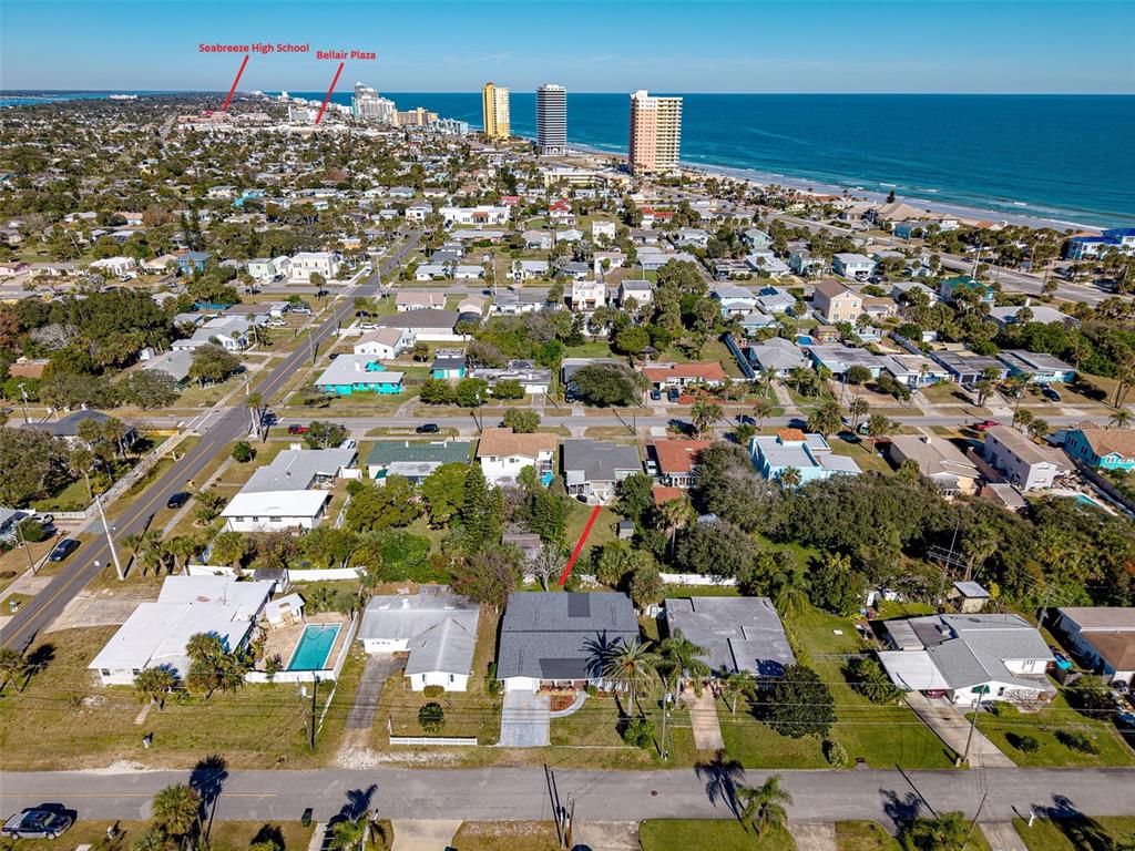 An aerial view shows a residential neighborhood near the ocean with a marked house — 417 MANHATTAN AVENUE, DAYTONA BEACH, FL