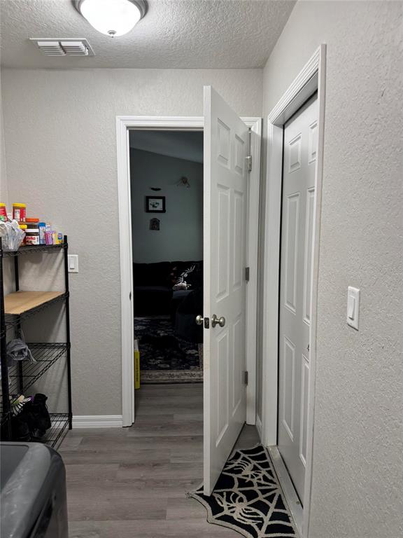 A laundry room features wire shelving, gray flooring, and two white interior doors — 19 WILLOW RUN, OCALA, FL