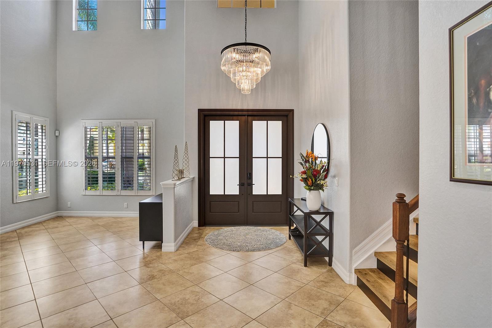 A kitchen features dark wood cabinetry, granite countertops, stainless steel appliances, and a central island — 3402 Vanderbilt Dr, Wellington FL 33414, WELLINGTON, FL