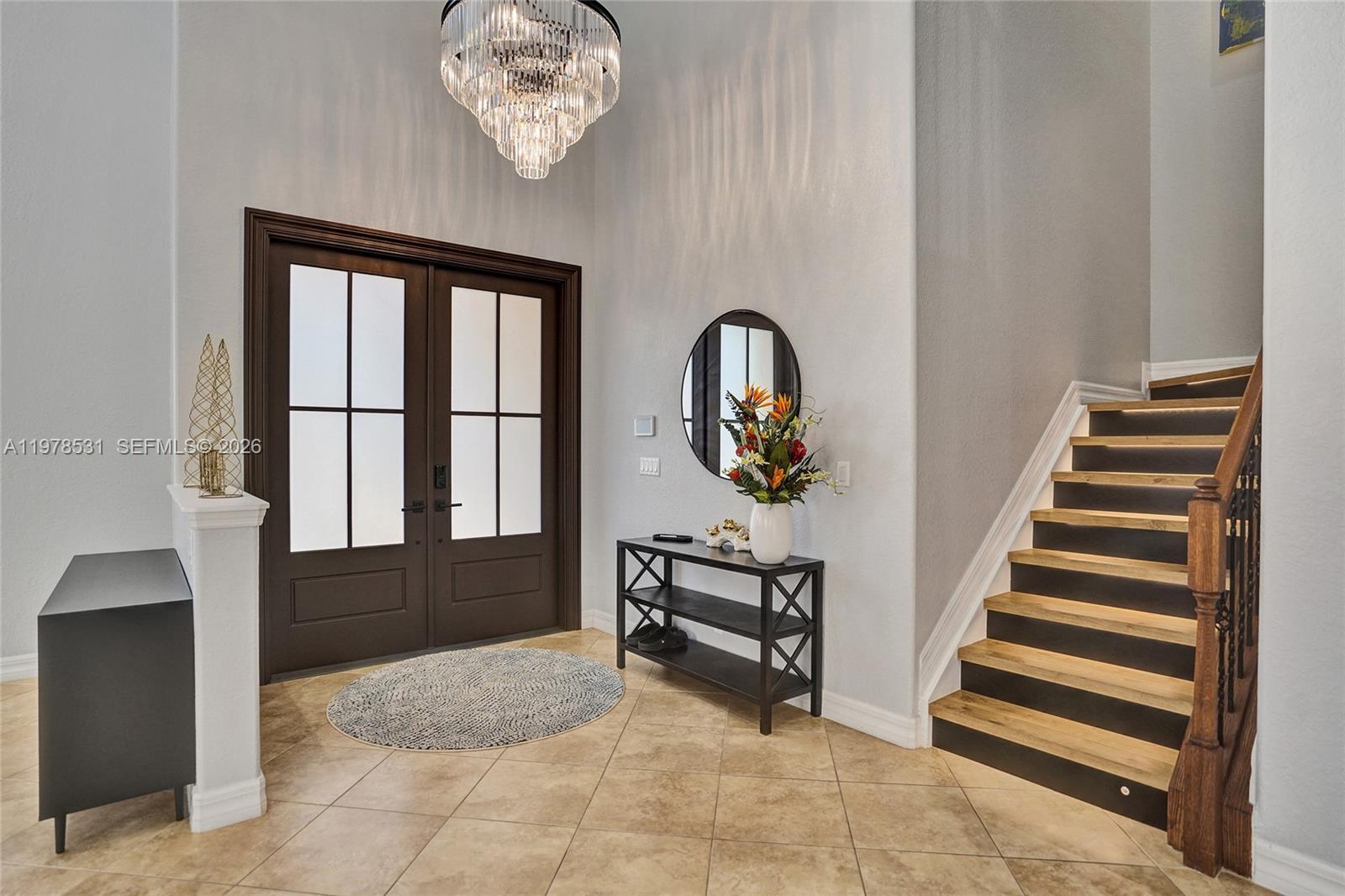 A bedroom features a canopy bed, a sliding barn door, and light wood-look flooring — 3402 Vanderbilt Dr, Wellington FL 33414, WELLINGTON, FL