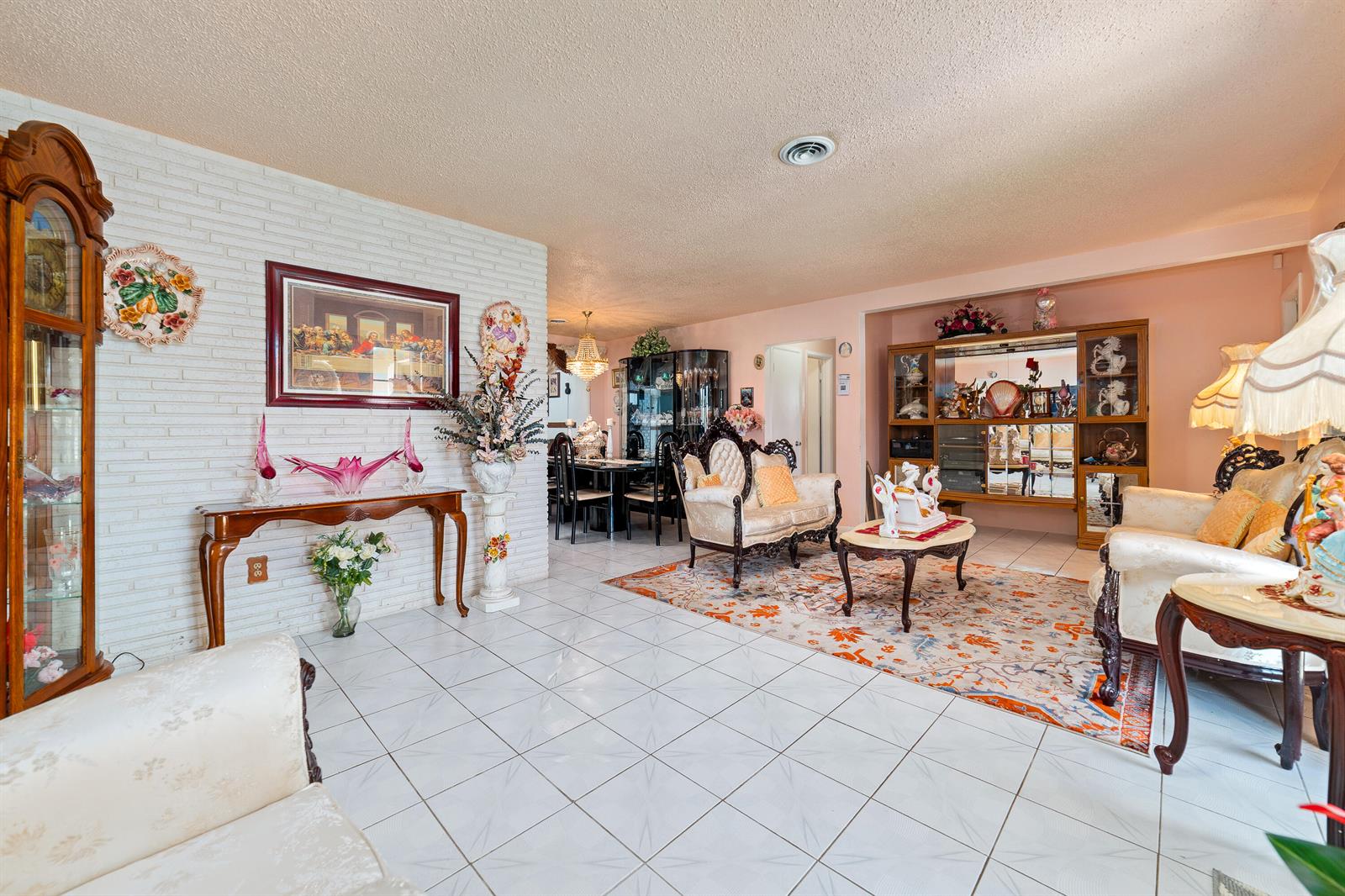 A living room with white tile floors, a brick wall, and ornate traditional furniture — 4460 NW 3rd Place, Plantation FL 33317, PLANTATION, FL