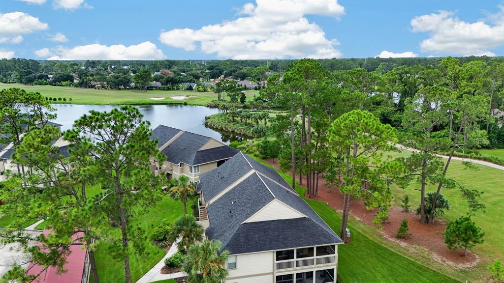 An aerial view of a multi-story residential building next to a lake and golf course — 31 MAGNOLIA DRIVE S, ORMOND BEACH, FL