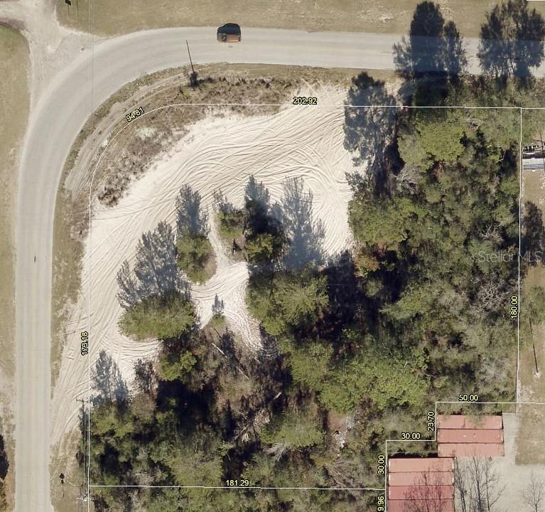 This is an aerial map showing a vacant, sandy corner lot with surrounding trees and roads — NORTHERN AVENUE, LEESBURG, FL