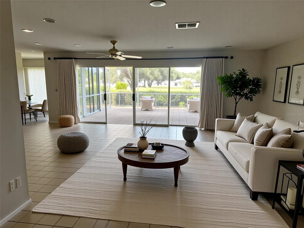 A living room features a beige sofa, round coffee table, and large sliding doors to a patio — 1225 GILLESPIE DRIVE N, PALM HARBOR, FL