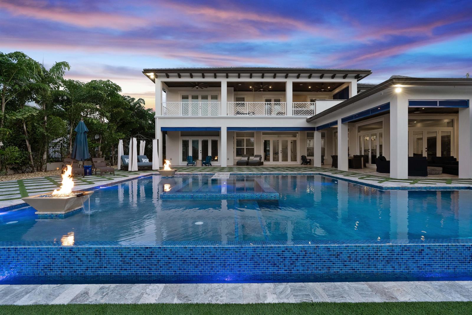 A two-story house with a blue-tiled infinity pool, fire features, and a covered patio — 261 Old Jupiter Beach Road, Jupiter FL 33477, JUPITER, FL