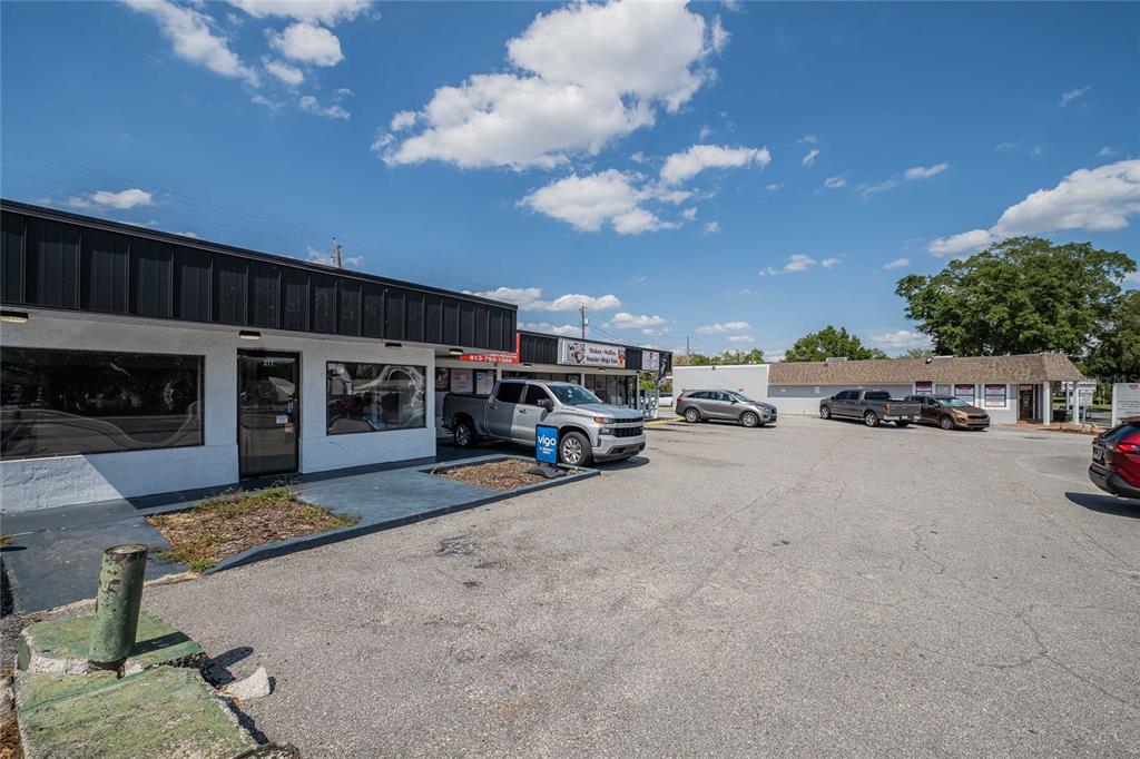 An exterior view of a single-story commercial building with a parking lot in front — 211 E CENTRAL AVENUE, WINTER HAVEN, FL