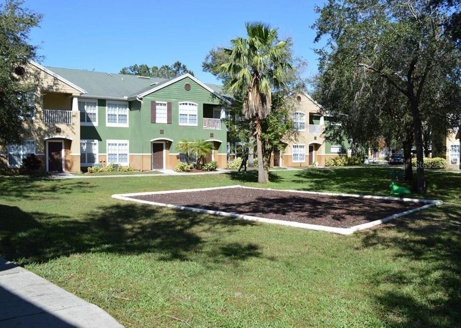 A living room with a beige sofa, tile floors, and an adjacent dining area — 4360 S KIRKMAN ROAD UNIT 408, ORLANDO, FL
