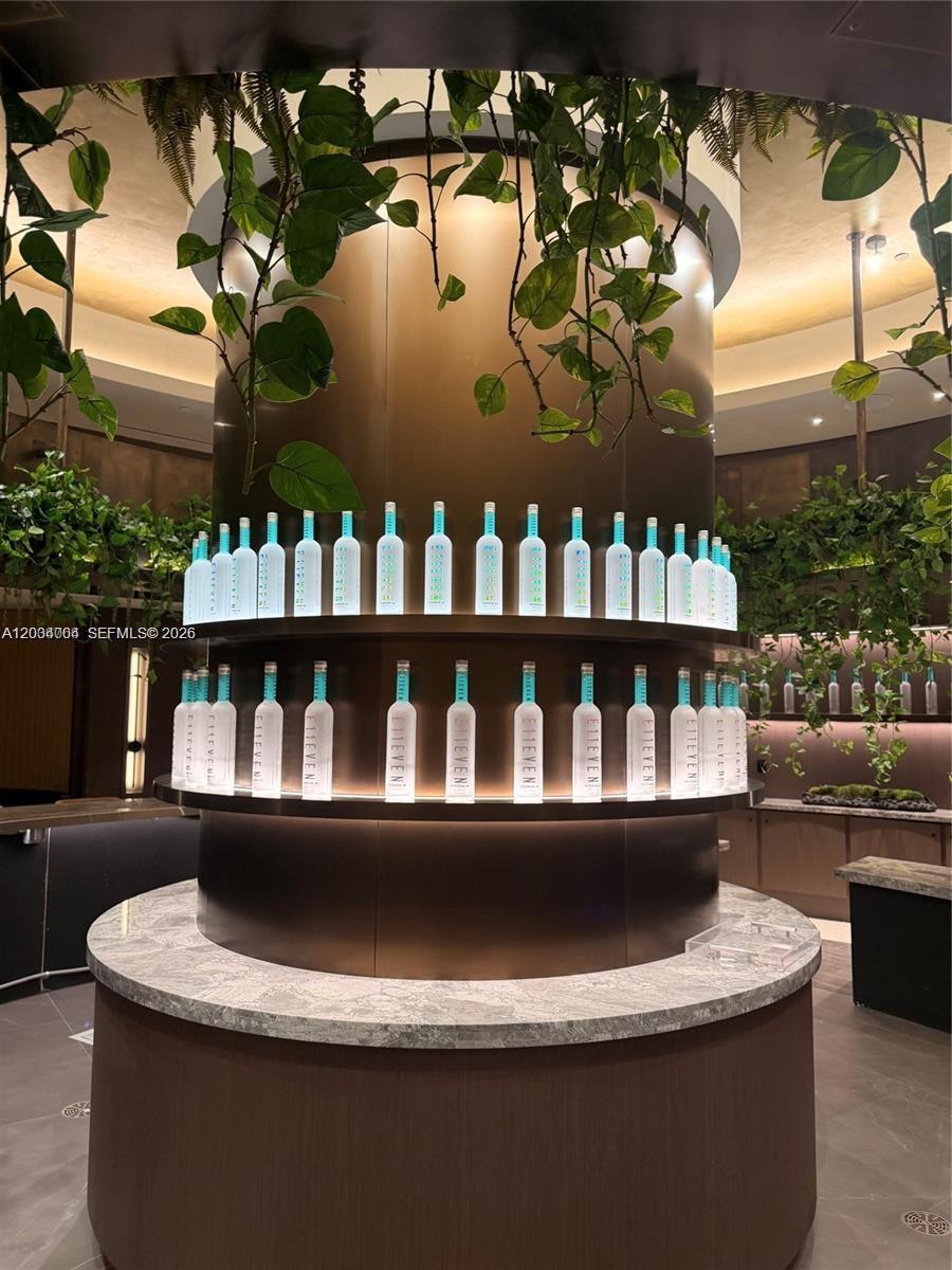 A circular bar features two tiers of illuminated shelves displaying E11EVEN vodka bottles — 20 NE 11th St # 3703A, Miami FL 33132, MIAMI, FL
