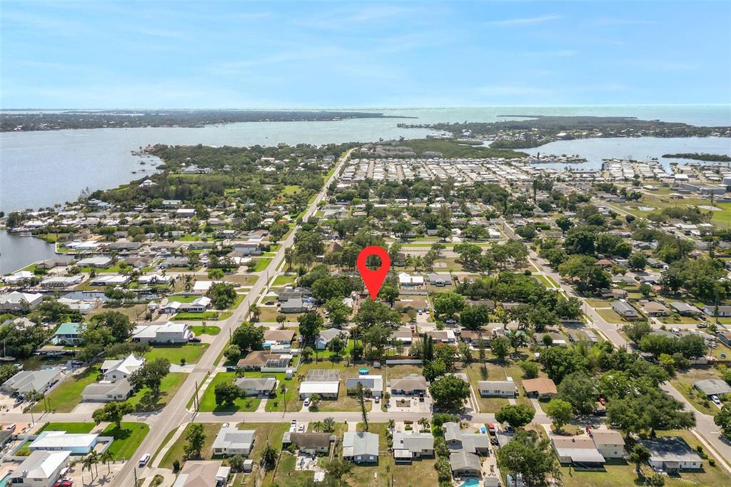 A single-story house with a garage, a large tree, and exterior lighting at dusk — 1007 22ND AVENUE W, PALMETTO, FL