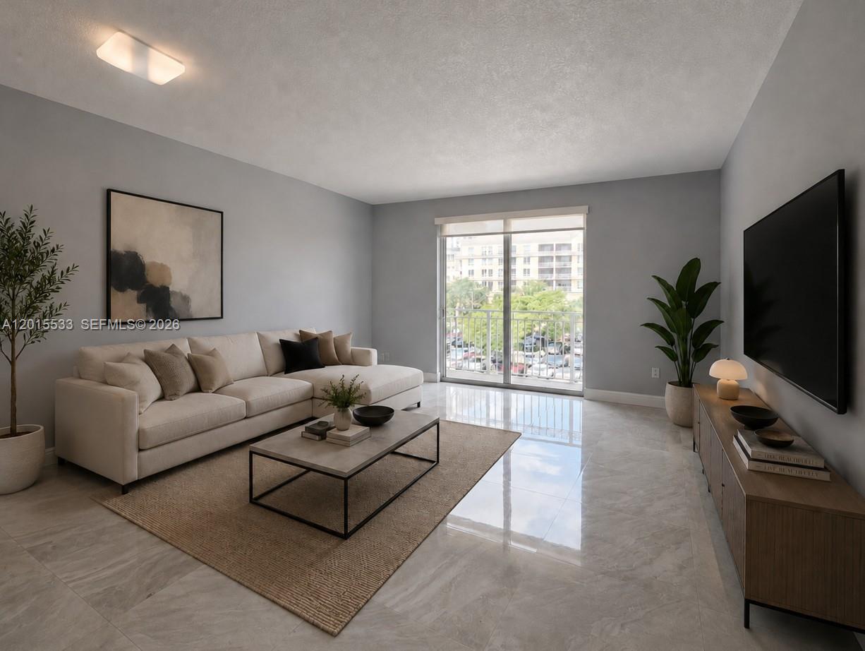 A modern living room features a beige sectional sofa, a coffee table, and a television — 7270 SW 88th St # B202, Miami FL 33156, MIAMI, FL
