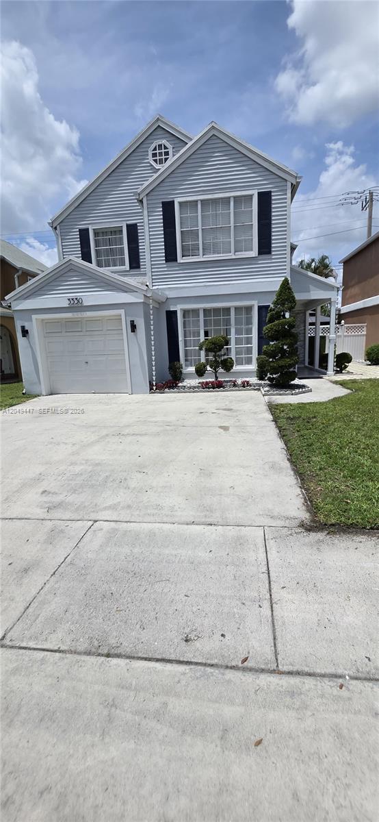 A two-story house with light blue siding, a single-car garage, and a concrete driveway — 3330 Kapot Ter, Miramar FL 33025, MIRAMAR, FL