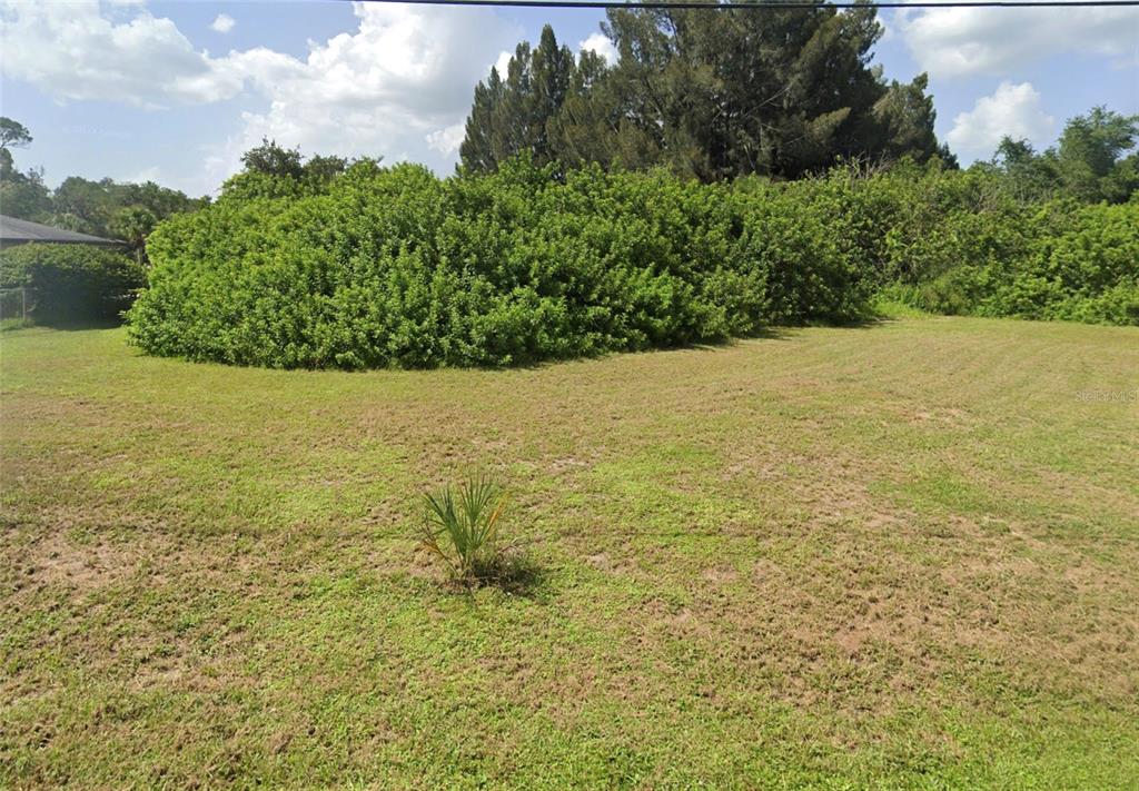This is an aerial map showing a vacant residential lot outlined in red — CORTEZ LANE, NORTH PORT, FL