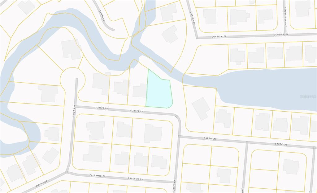A grassy, open lot features a large, dense cluster of green bushes and tall trees — CORTEZ LANE, NORTH PORT, FL