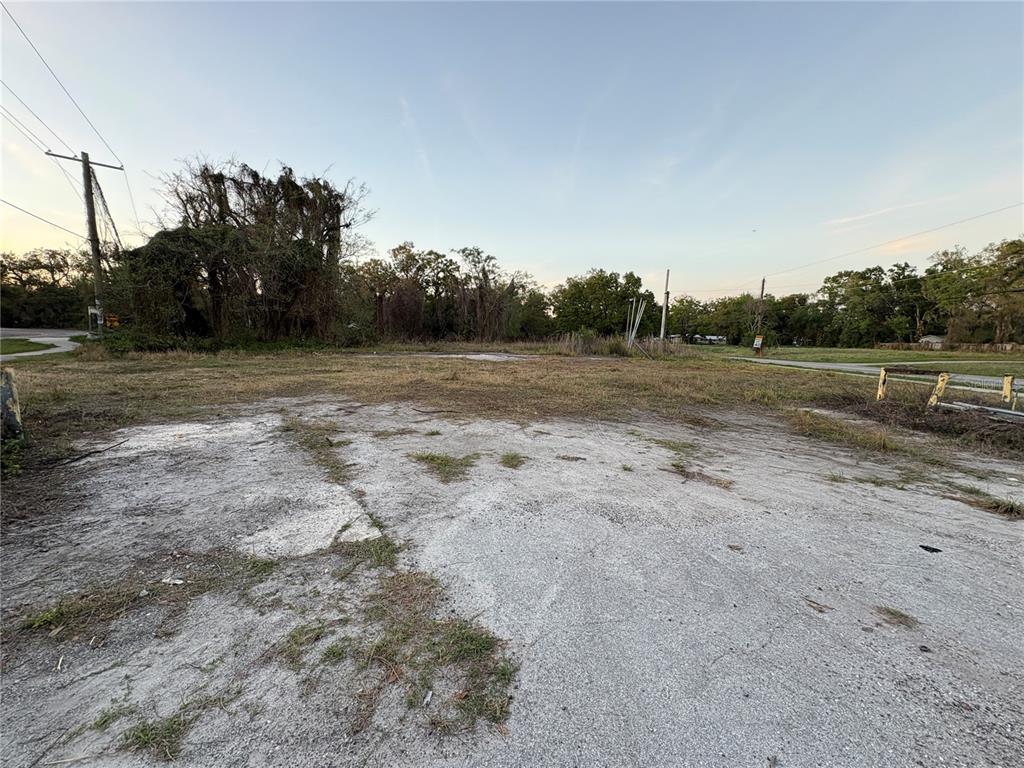 An empty, flat, grassy lot with a patch of gravel in the foreground — 535 MAYDELL DRIVE, TAMPA, FL