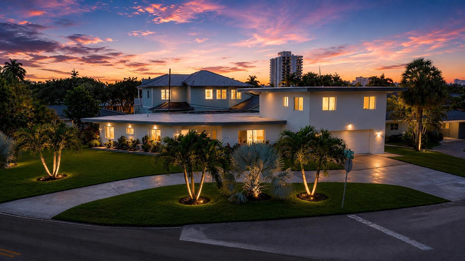 An exterior view of a modern two-story house with a circular driveway at sunset — 2812 NE 27th Street, Lighthouse Point FL 33064, LIGHTHOUSE POINT, FL