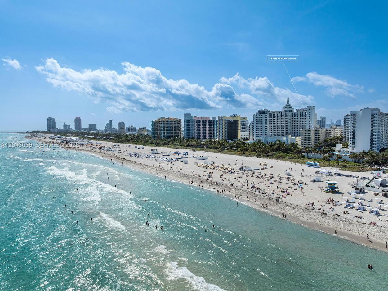 An aerial view of a sandy beach with ocean waves and high-rise buildings — 1623 Collins Ave, Miami Beach FL 33139, MIAMI BEACH, FL