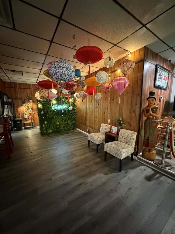 A room with wood-paneled walls, hanging paper lanterns, and two patterned chairs — 8256 ULMERTON ROAD, LARGO, FL