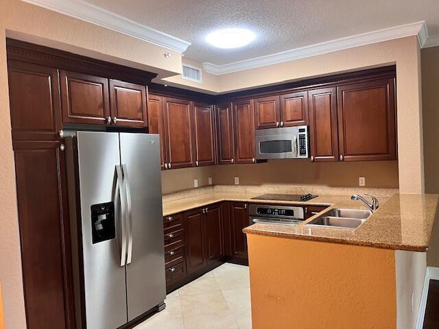 A kitchen with dark wood cabinets, stainless steel appliances, and granite countertops — 4 Renaissance Way # 302, Boynton Beach FL 33426, BOYNTON BEACH, FL