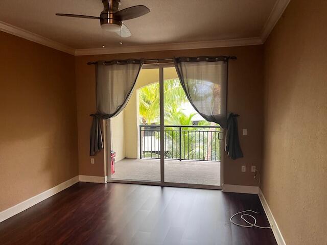 An empty room with dark wood floors, a ceiling fan, and sliding doors to a balcony — 4 Renaissance Way # 302, Boynton Beach FL 33426, BOYNTON BEACH, FL