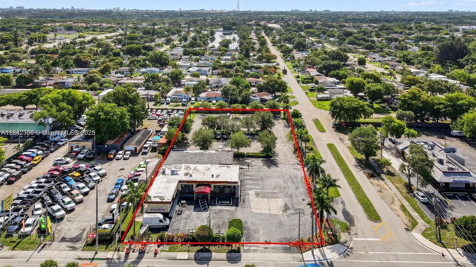 An aerial view shows a commercial building with a large parking lot outlined in red — 4950 S State Road 7, Hollywood FL 33314, HOLLYWOOD, FL