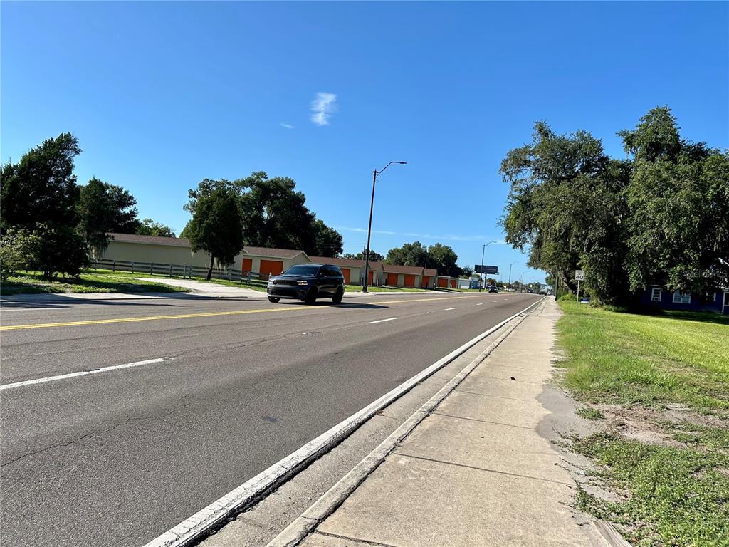 A dark SUV drives on a paved road past a row of storage units — 109 ORANGE STREET, BOWLING GREEN, FL