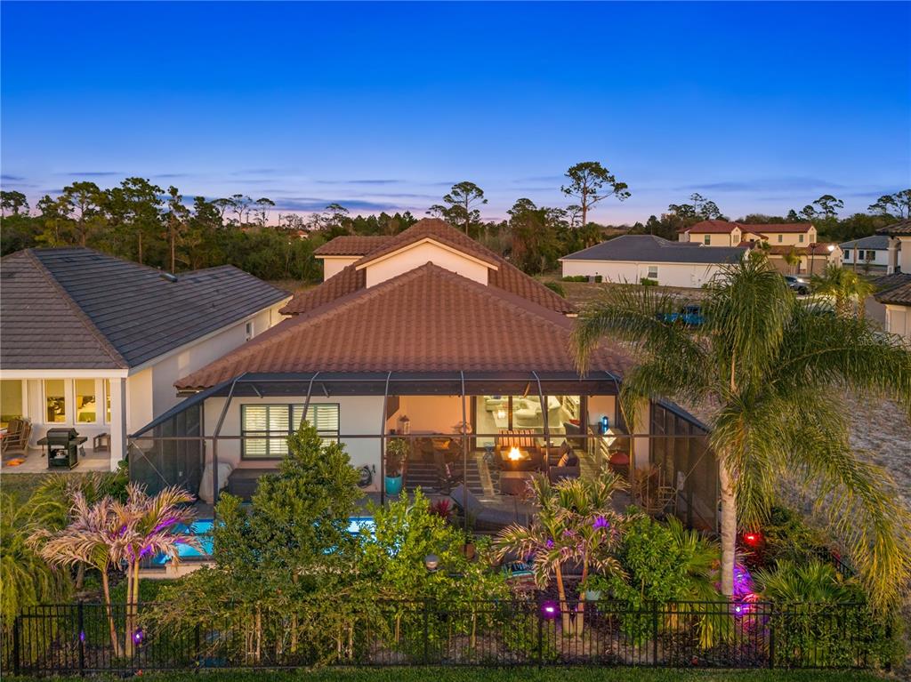 An aerial view of a house with a screened-in pool, patio, and backyard landscaping — 5 RIO VISTA DRIVE, PALM COAST, FL